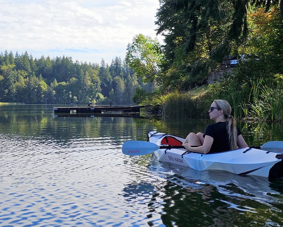 Woman in kayak on river