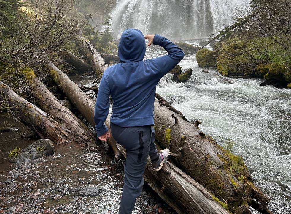 Man looking at waterfall