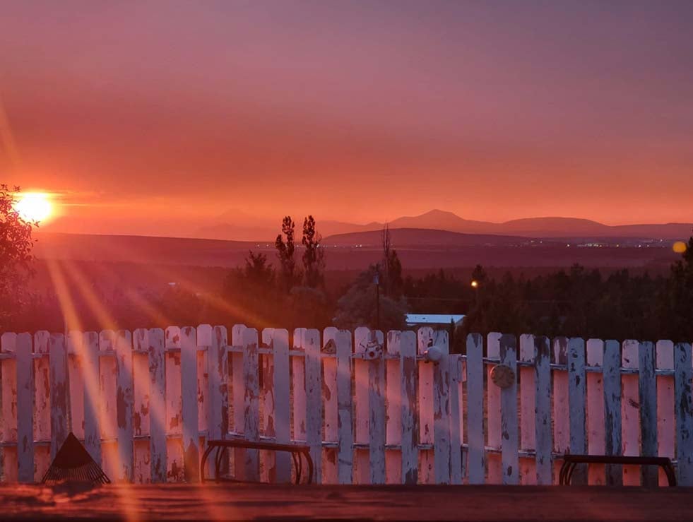 View of Juniper Canyon at sunset from a backyard