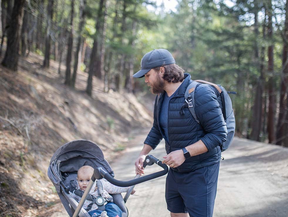 Man pushing a stroller on a hiking tail