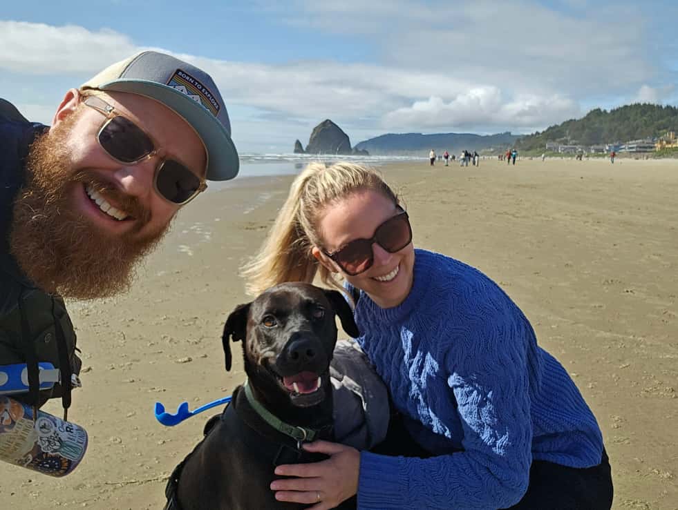 Man and woman on Cannon Beach with their dog