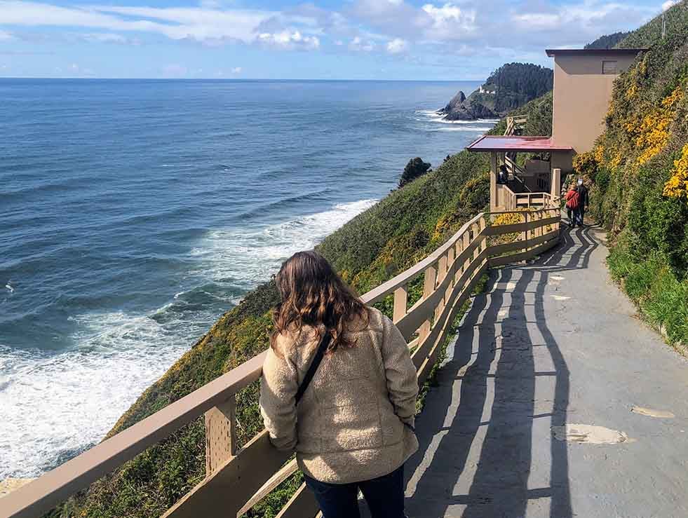 Woman admiring view along pathway to Sea Lion Caves