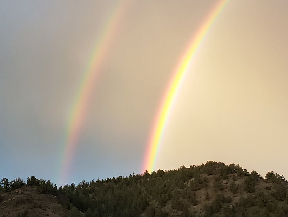 Double Rainbow over hill